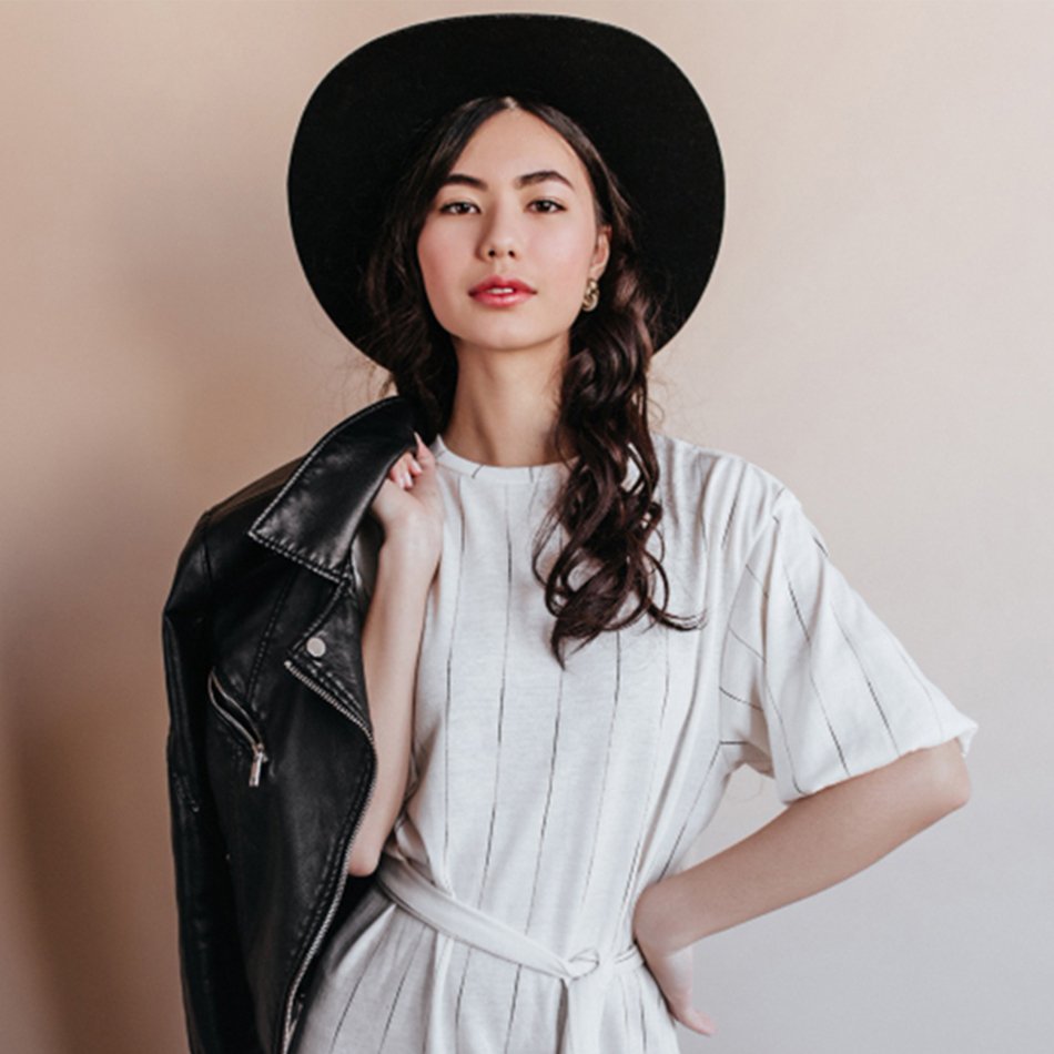elegant-asian-woman-white-dress-looking-camera-confident-chinese-woman-hat-holding-leather-jacket